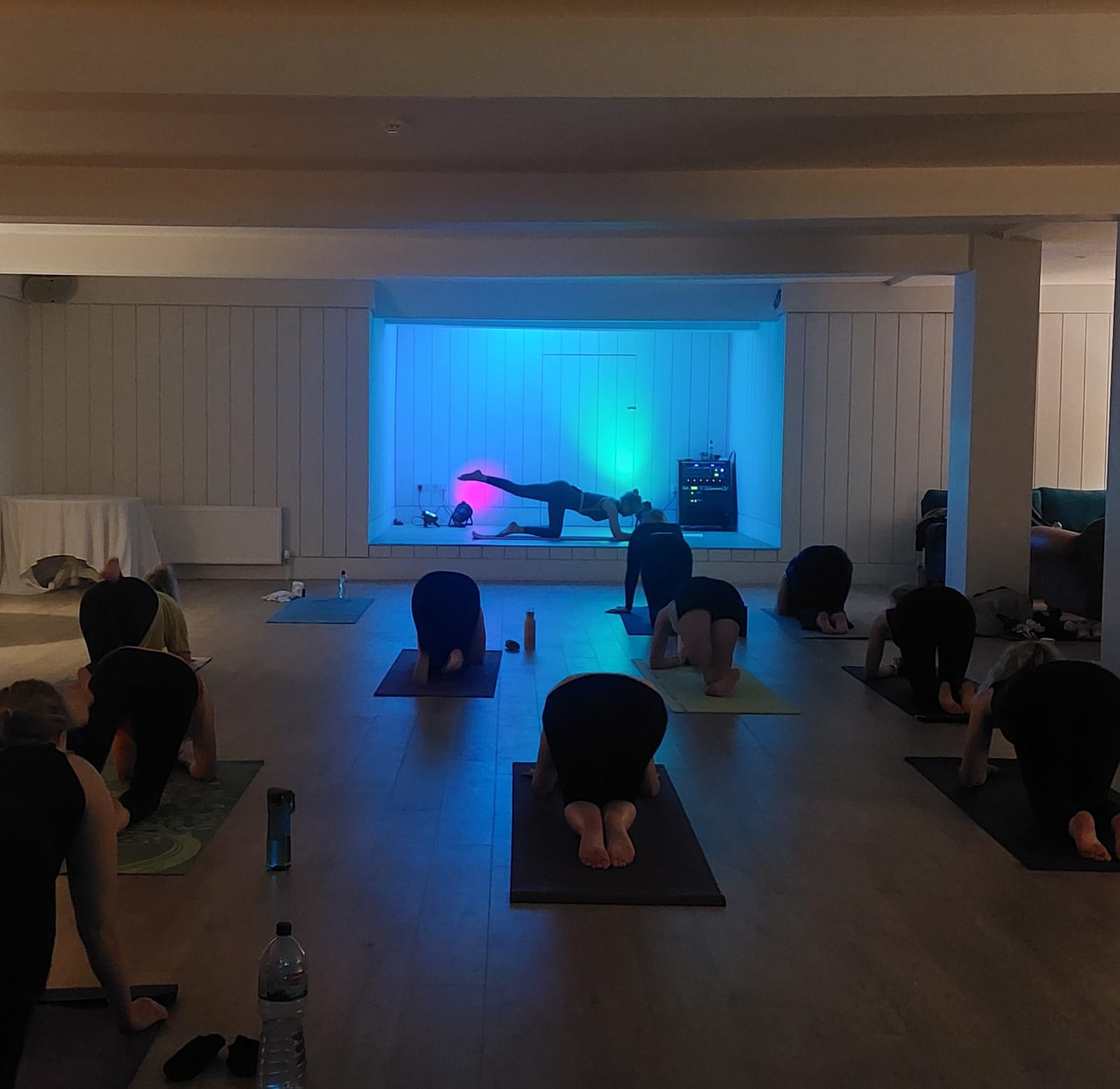 YogaliciousCLUB class inside Sally's Nightclub with coloured lighting